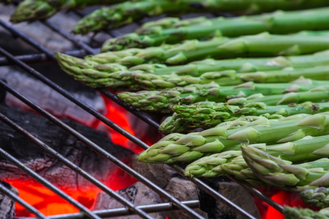 Close up of asparagus being grilled on a bbq
